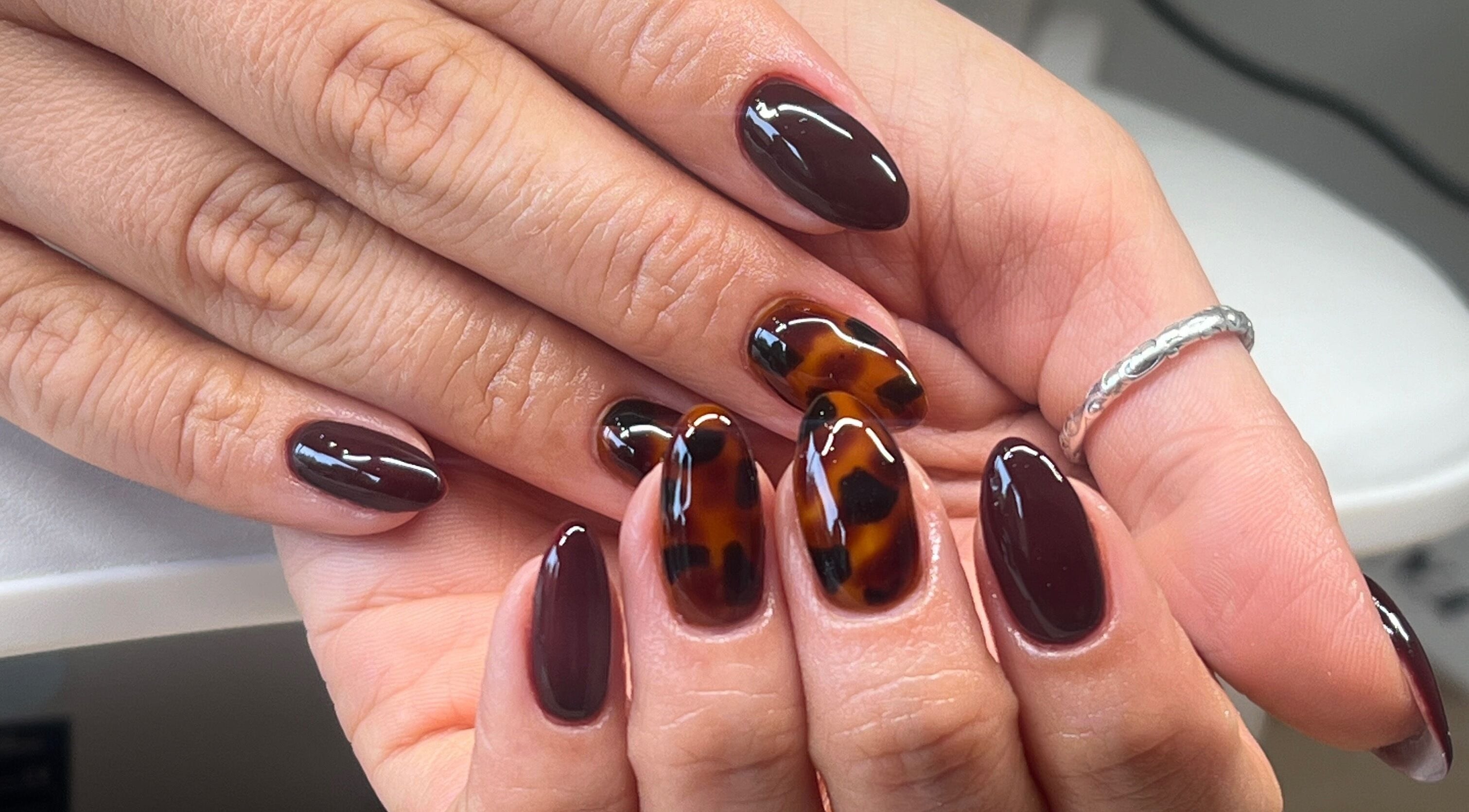 Tortoiseshell nail art at Serene Mani’s in Stevenage, England, GB, showcasing stylish and polished hands.