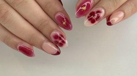 Stylish floral nail art by Kpurenails in Cambridge, Waikato Region, NZ. Showcasing intricate red designs.