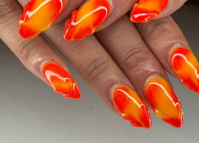 Fiery red and orange nails at Kpurenails in Cambridge, Waikato Region, NZ, showcasing bold nail art.