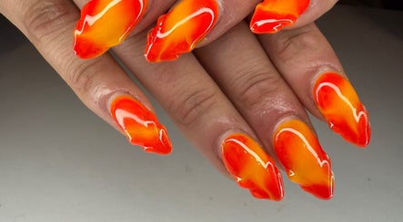 Fiery red and orange nails at Kpurenails in Cambridge, Waikato Region, NZ, showcasing bold nail art.