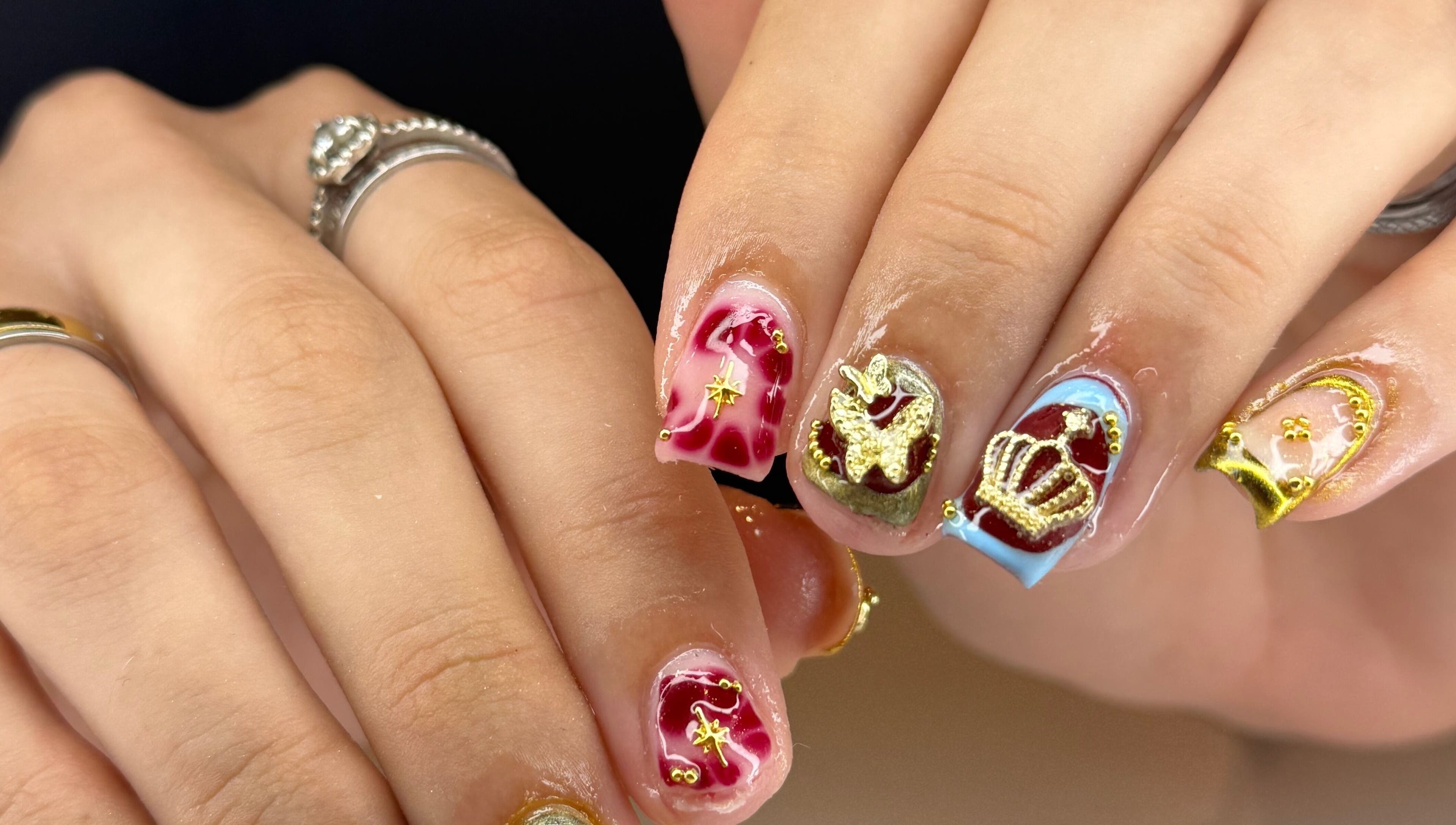 Intricate nail art with gold and maroon designs at Kpurenails, Cambridge, Waikato Region, NZ.