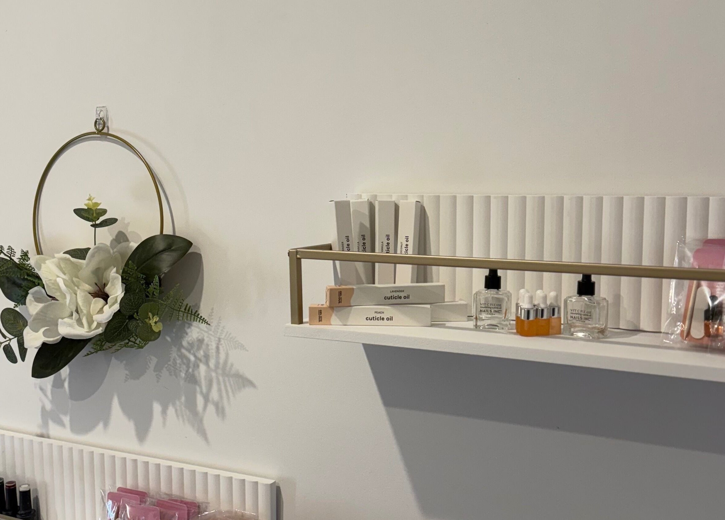 Elegant nail care display at Kpurenails, Cambridge, Waikato Region, NZ, showcasing oils and floral decor.