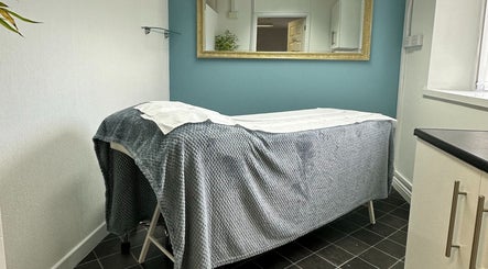 Treatment room at Arvor Nails and Beauty, Camborne, England, GB, featuring a plush bed with a cozy grey cover.