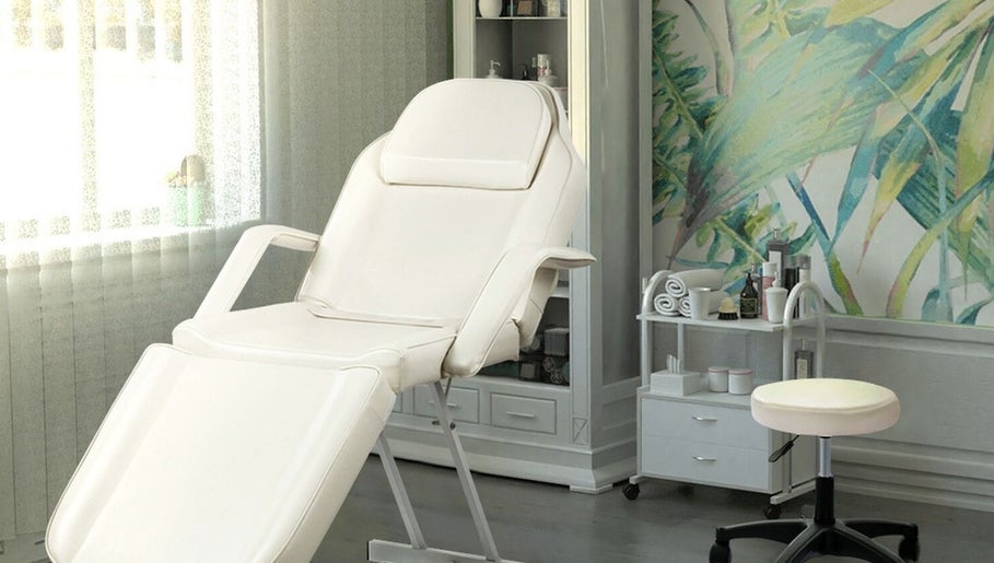 Relaxing spa treatment room with white chair at The Brilliance Bar, Olney, England, GB.