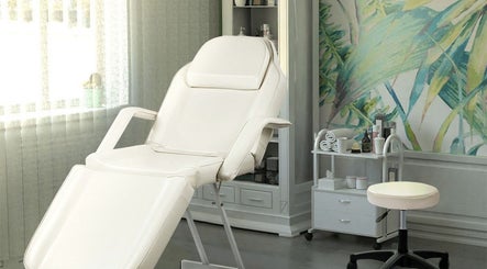 Relaxing spa treatment room with white chair at The Brilliance Bar, Olney, England, GB.