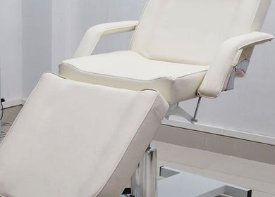 Elegant white spa bed at The Brilliance Bar, Olney, England, GB, showcasing a serene wellness setting.