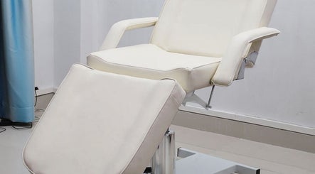 Elegant white spa bed at The Brilliance Bar, Olney, England, GB, showcasing a serene wellness setting.