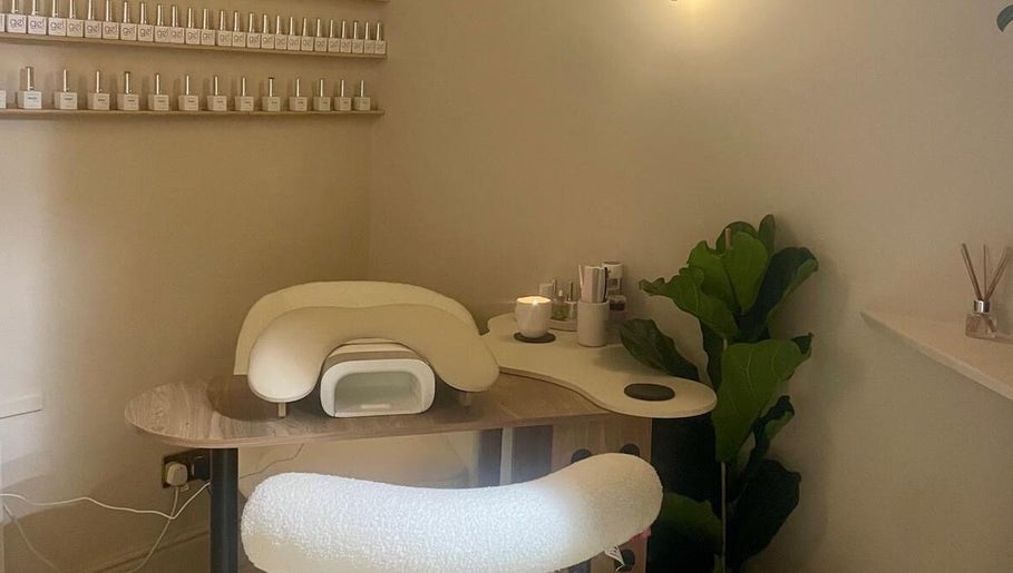 Nail station at Bare. Beauty Studio in Bradford, England, GB, featuring a plush chair and polish display.
