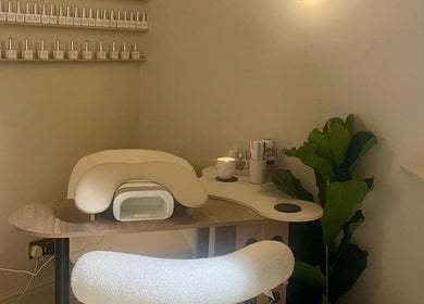 Nail station at Bare. Beauty Studio in Bradford, England, GB, featuring a plush chair and polish display.