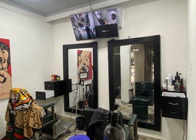 Interior moderno de Europa Barber Shop en Neiva, Huila, CO, con espejos y decoración artística.