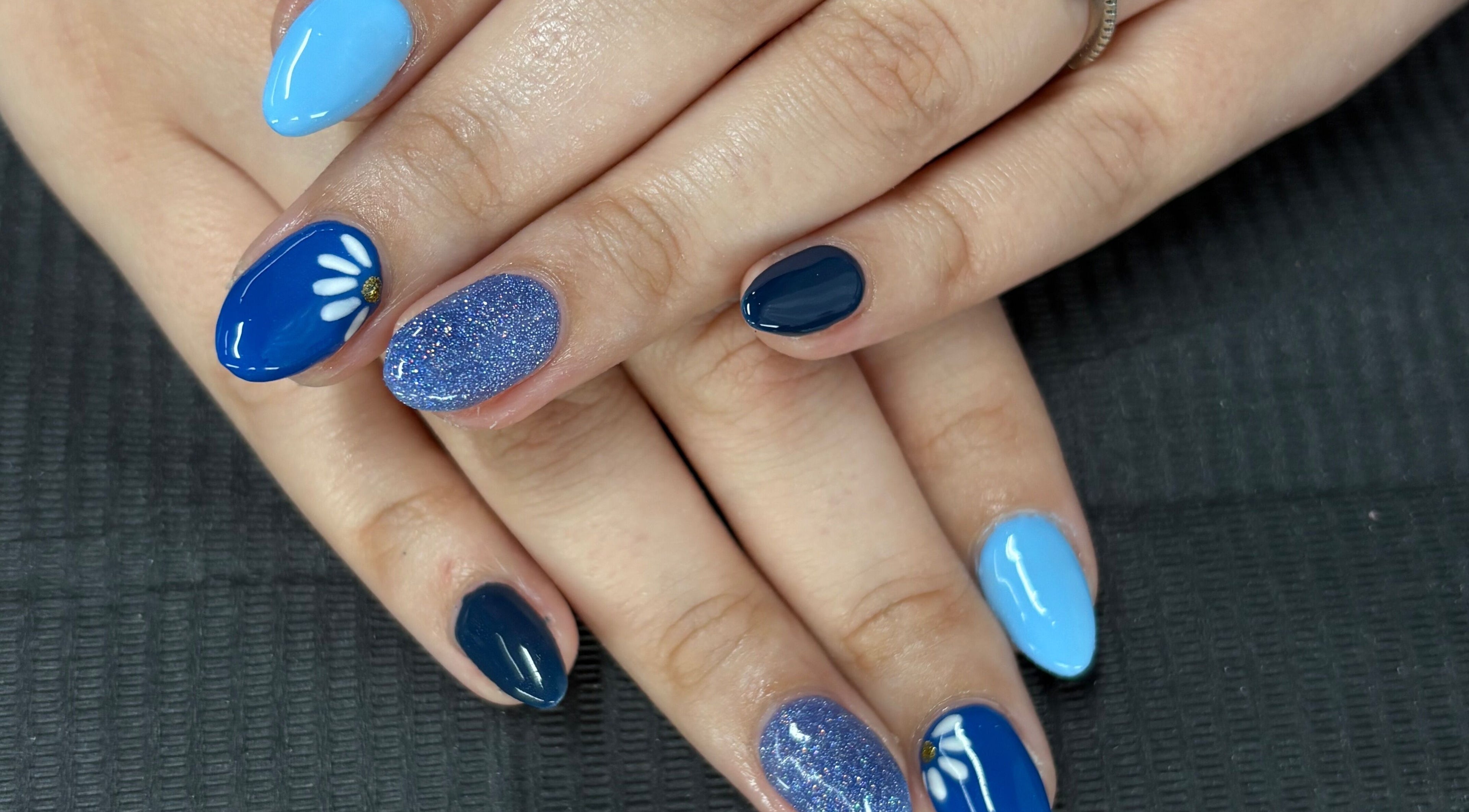 Stylish blue floral nails at Mudnmilk nails and beauty, Emanzimtoti, Kwazulu-natal, ZA.