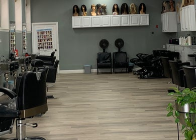 Spacious, elegant salon interior at Styles, Haverhill, Massachusetts, US with modern styling stations and wigs.