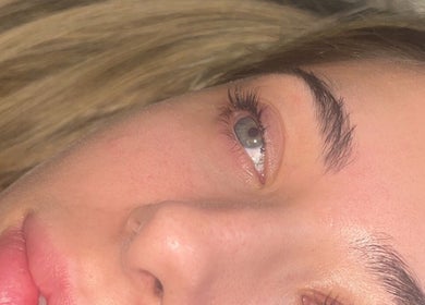 Close-up of a serene face with glowing skin at Beauty Pod by Ell, Middlesbrough, England, GB.