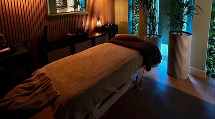 Tranquil massage room at Ella Foss - Massage Therapist, Vale, GG, with soothing lighting and elegant decor.