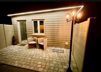 Cozy outdoor patio at Ella Foss - Massage Therapist in Vale, GG, featuring elegant lighting and seating.