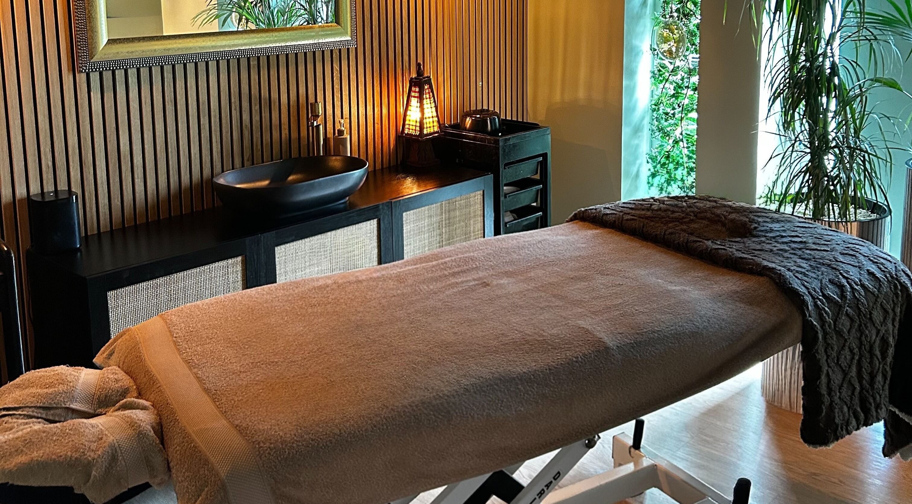 Elegant massage room at Ella Foss - Massage Therapist, Vale, GG. Cozy table and tranquil decor.