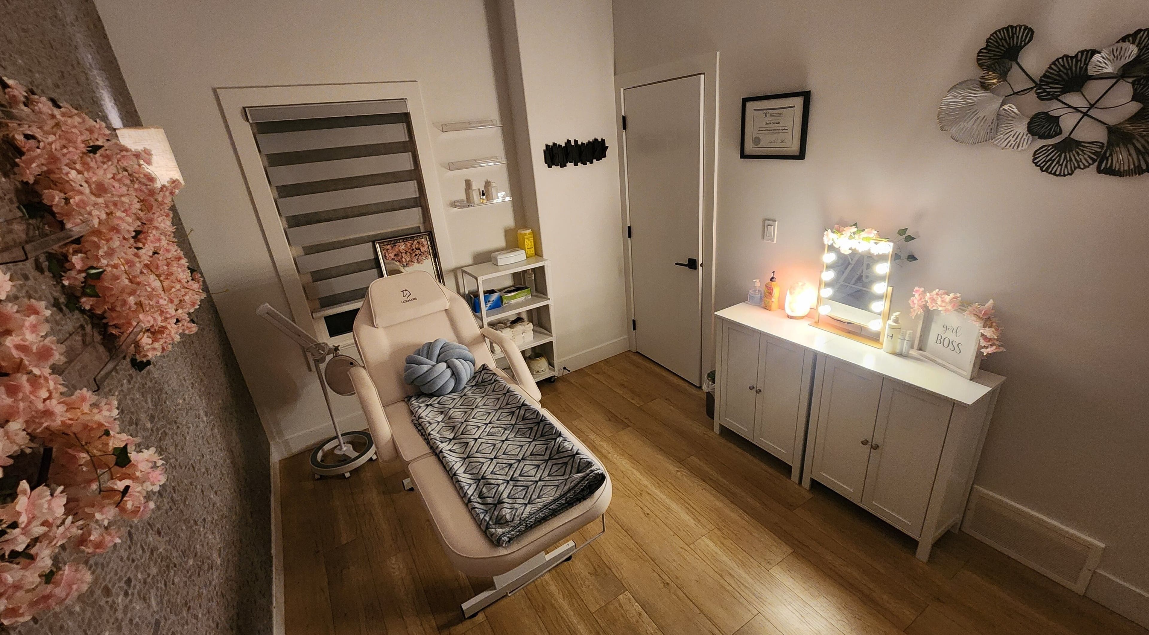 Cozy beauty treatment room at C&C BeautyBar, Leduc, Alberta, CA with floral decor and plush seating.