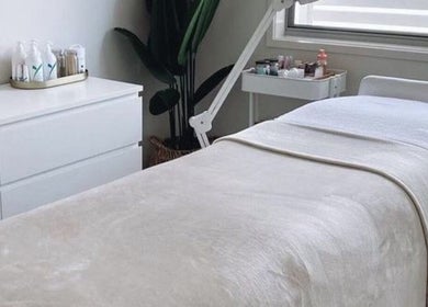 Relaxing treatment room at Browcandylondon, Milton Keynes, England, GB, featuring a cozy bed and elegant decor.