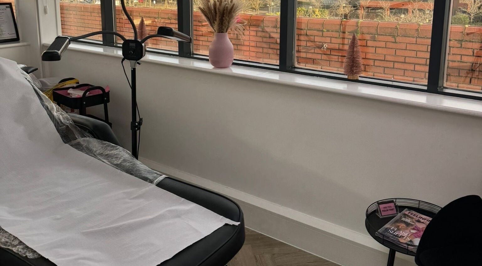 Cozy treatment room at Browed by Min, Milton Keynes, England, GB with a bed, soft lighting, and decor.