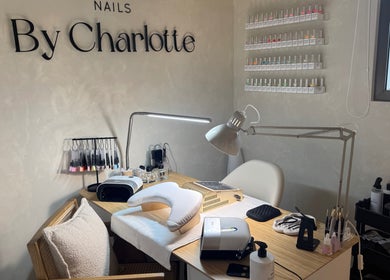 Chic nail salon setup at Nails By Charlotte, Dubai, Dubai, AE, showcasing tools and polish options.