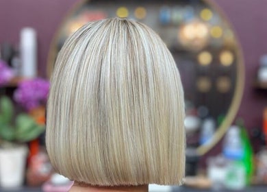 Blonde bob haircut at Persepolis Unisex Salon, London, England, GB with stylish salon decor.