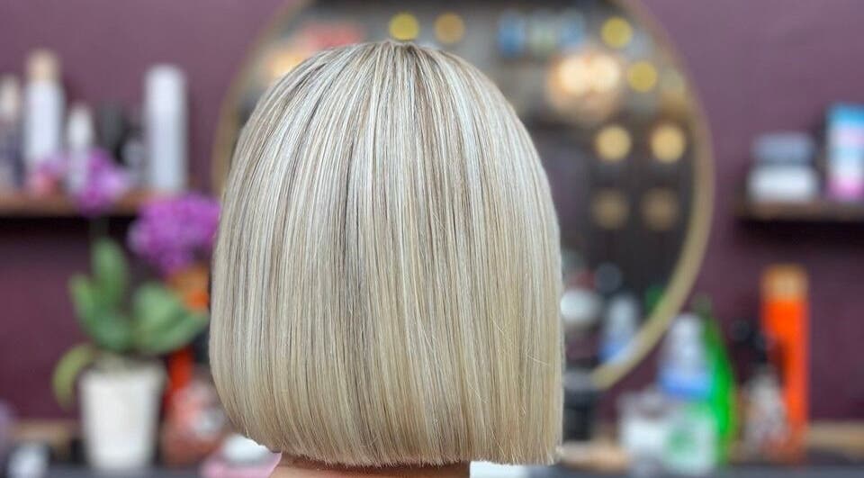 Blonde bob haircut at Persepolis Unisex Salon, London, England, GB with stylish salon decor.