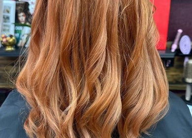 Styled ginger hair at Persepolis Unisex Salon, London, England, GB, showcasing vibrant curls.