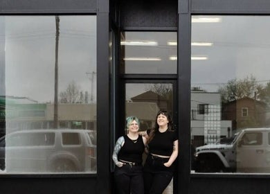 Front view of Fern & Moody Salon, Chicago, Illinois, US featuring two smiling people.