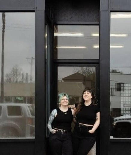 Front view of Fern & Moody Salon, Chicago, Illinois, US featuring two smiling people.