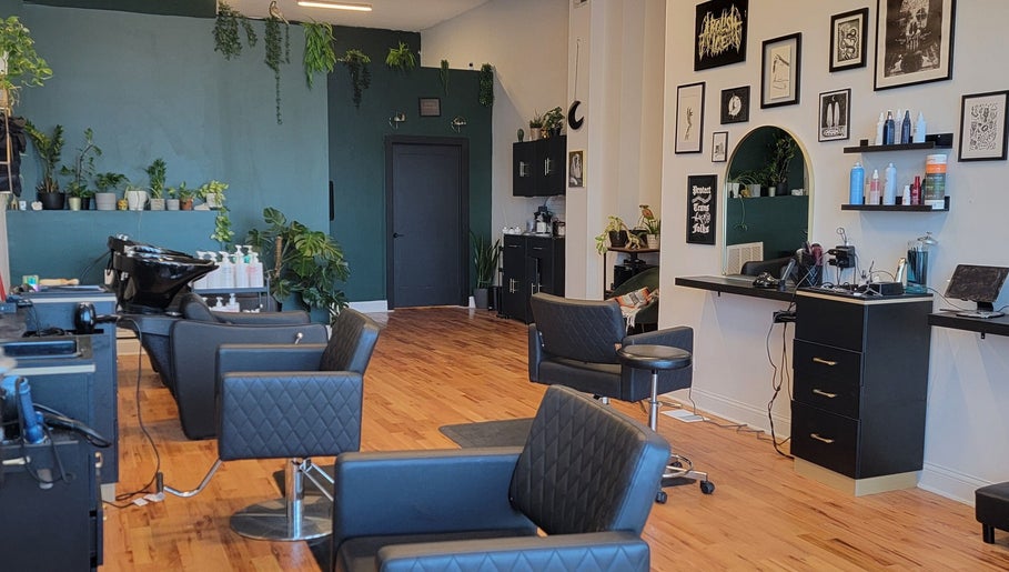 Inside The Hair Shepard salon in Chicago, Illinois, US showcasing stylish chairs and lush greenery.