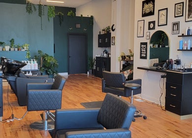 Inside The Hair Shepard salon in Chicago, Illinois, US showcasing stylish chairs and lush greenery.