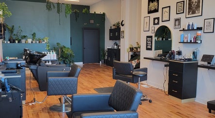 Inside The Hair Shepard salon in Chicago, Illinois, US showcasing stylish chairs and lush greenery.