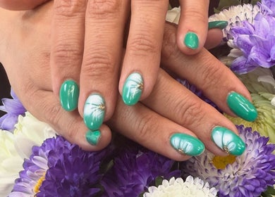 Green manicured nails with floral designs at maison de femme, Bristol, England, GB.