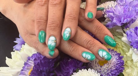 Green manicured nails with floral designs at maison de femme, Bristol, England, GB.