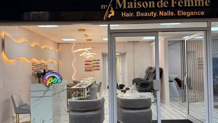 Entrance to Maison de Femme beauty salon in Bristol, England, GB showing chic interior and a neon open sign.