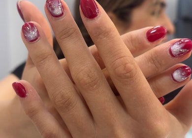 Red manicure with white accents at Maison de Femme, Bristol, England, GB.