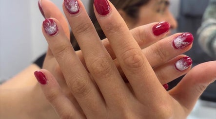 Red manicure with white accents at Maison de Femme, Bristol, England, GB.