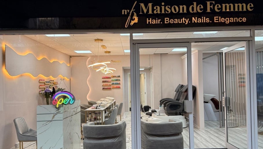 Entrance of Maison De Femme, a stylish beauty haven in Bristol, England, GB with a welcoming neon sign.