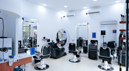 Modern interior of Umatura Barber Canggu in Bali, Bali, ID, featuring sleek black chairs and mirrors.