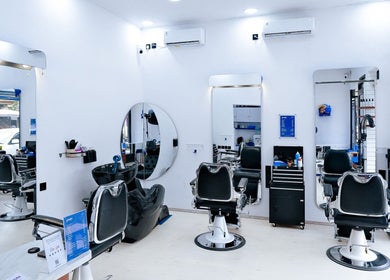 Modern interior of Umatura Barber Canggu in Bali, Bali, ID, featuring sleek barber chairs and mirrors.