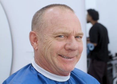 A satisfied client smiling after a haircut at Umatura Barber Canggu, Bali, Bali, ID.