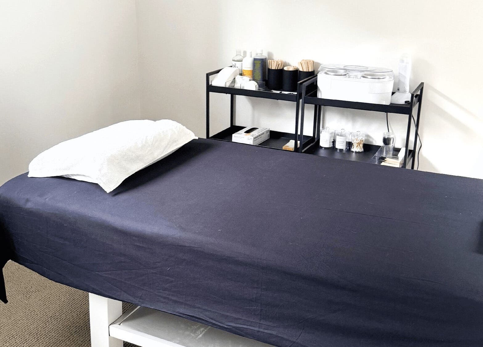 Massage room at All Things Me in Whangaparāoa, Auckland, NZ, featuring a treatment bed and relaxing ambiance.