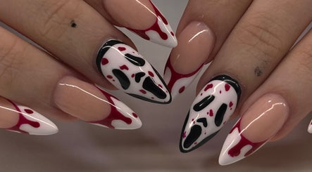 Creative nail art design at Swaggie Nailz in Brick Township, New Jersey, US showcasing red and black accents.