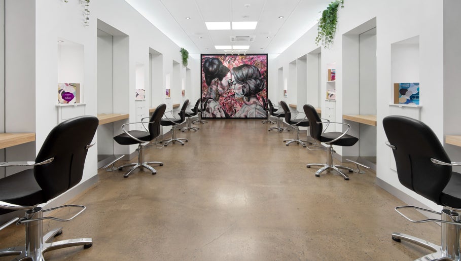 Interior of Helmet Hair Studio in Darwin City, Northern Territory, AU with modern styling chairs and decor.