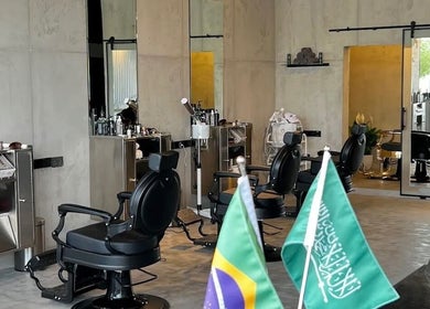 Modern interior of FANE BARBERSHOP in Jeddah, Makkah Province, SA with stylish chairs and decor.