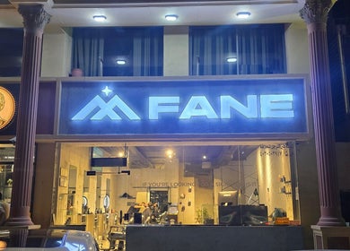 Front view of Fane Barbershop in Jeddah, Makkah Province, SA with illuminated signage.