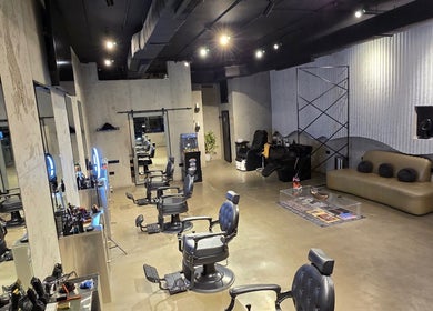 Modern interior of Fane Barbershop in Jeddah, Makkah Province, SA, with stylish seats and sleek decor.