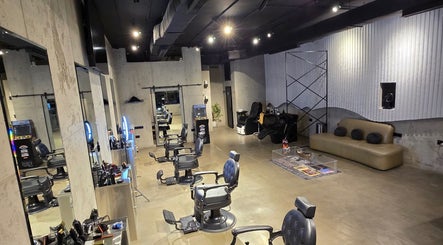 Modern interior of Fane Barbershop in Jeddah, Makkah Province, SA, with stylish seats and sleek decor.