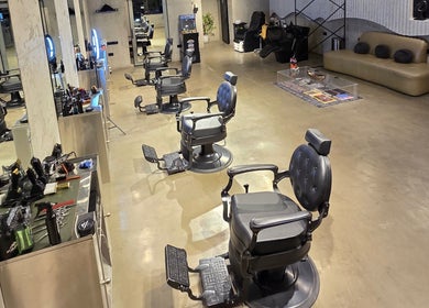 Elegant barber chairs at Fane Barbershop, Jeddah, Makkah Province, SA, showcasing a modern and spacious interior.