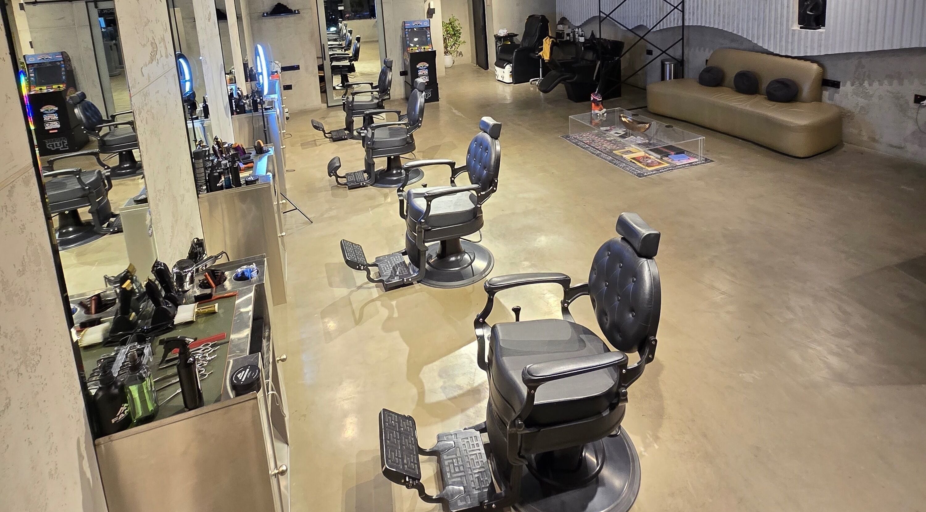Elegant barber chairs at Fane Barbershop, Jeddah, Makkah Province, SA, showcasing a modern and spacious interior.